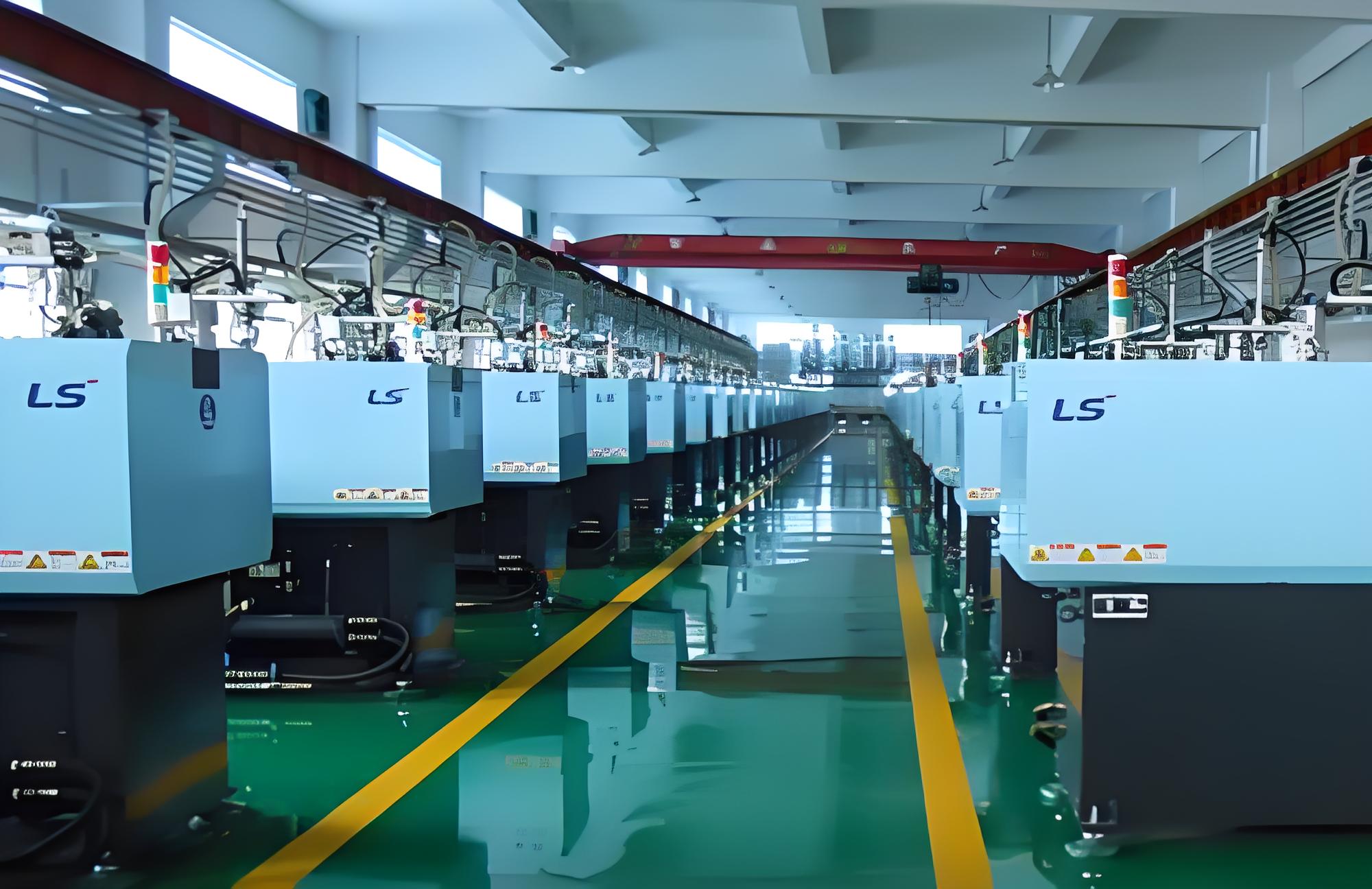 An industrial injection molding facility with a large machine in operation.