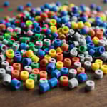 ABS, PP, and PVC pellets with injection molding machine in the background.