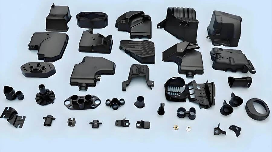 A collection of black plastic automotive components arranged orderly