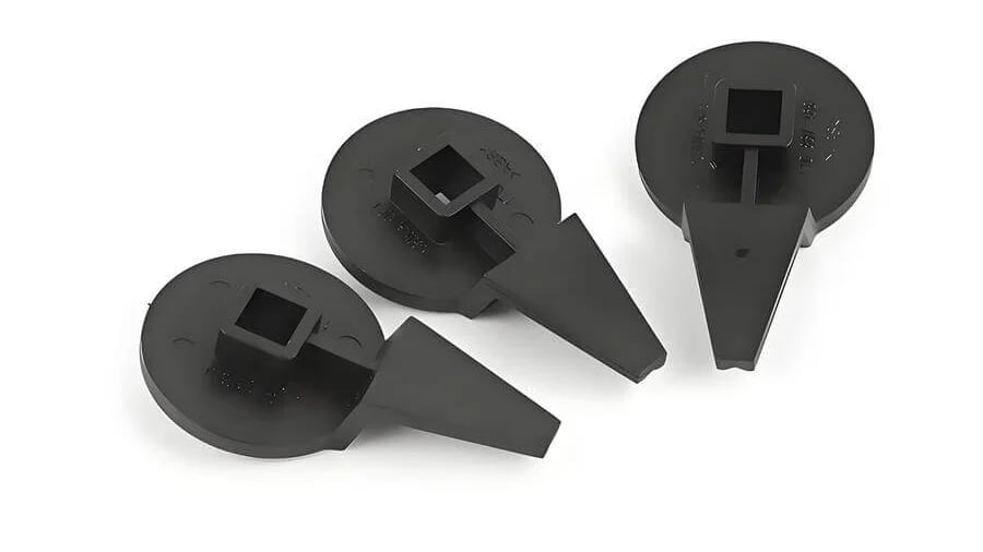 Three identical black plastic tool attachments arranged in a row.