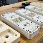 Close-up view of plastic injection molded parts showing manufacturing defects