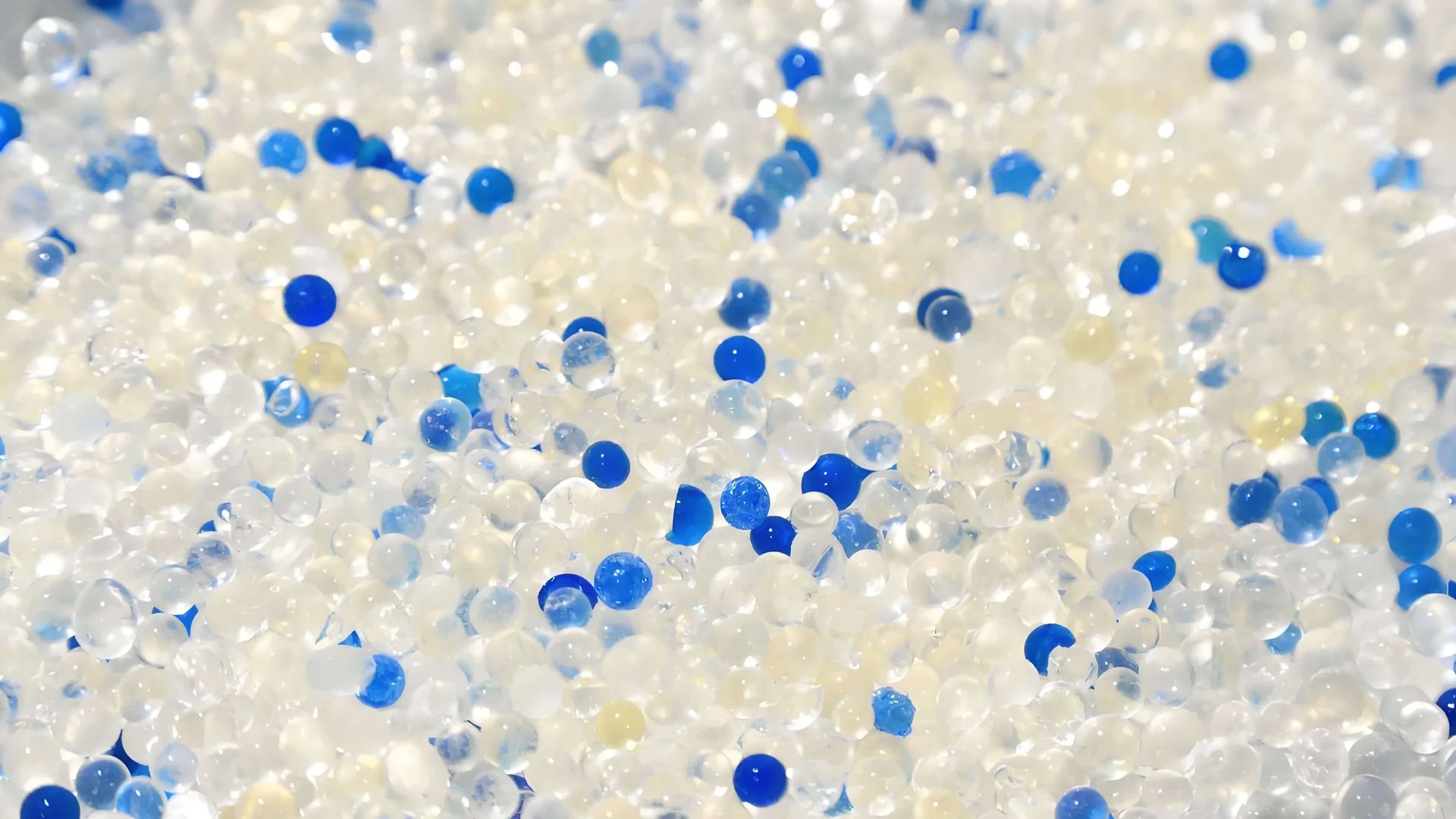 Close-up of a vibrant collection of transparent and blue spherical beads