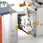 Detailed view of a partially open injection mold showcasing its core and cavity structure.