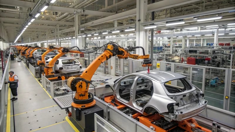 High-tech automotive manufacturing facility with robotic arms and workers