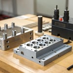 Close-up of injection mold parts on a workbench