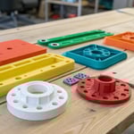 Collection of colorful plastic components on a wooden workbench