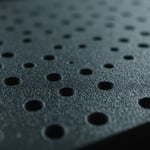 Close-up of a polypropylene injection molded product with visible shrinkage issues.