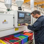 A technician studying a control panel in a factory
