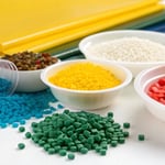 Close-up of colorful plastic materials including pellets and sheets