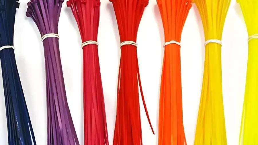 Close-up of black plastic cable ties on wooden surface
